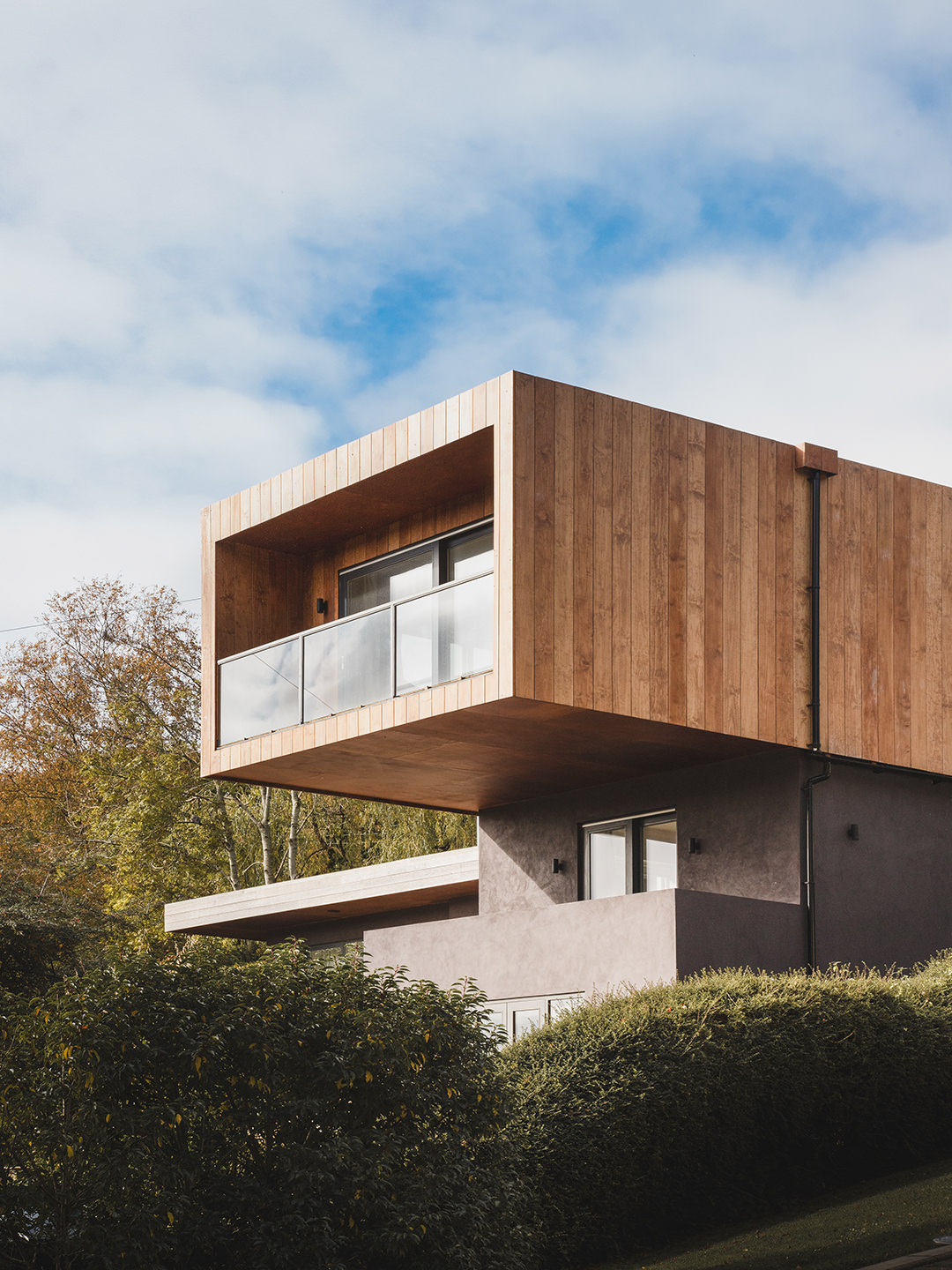 A wooden clad geometric modern building of architectural interest